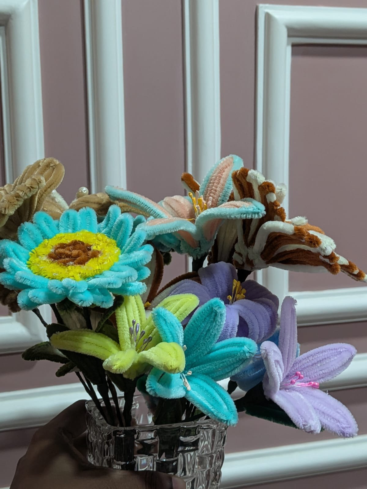 Close-up of teal, purple, and chartreuse crochet flowers