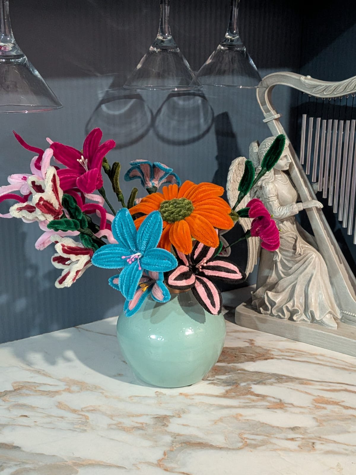 Colourful mixed crochet flower bouquet in a mint vase