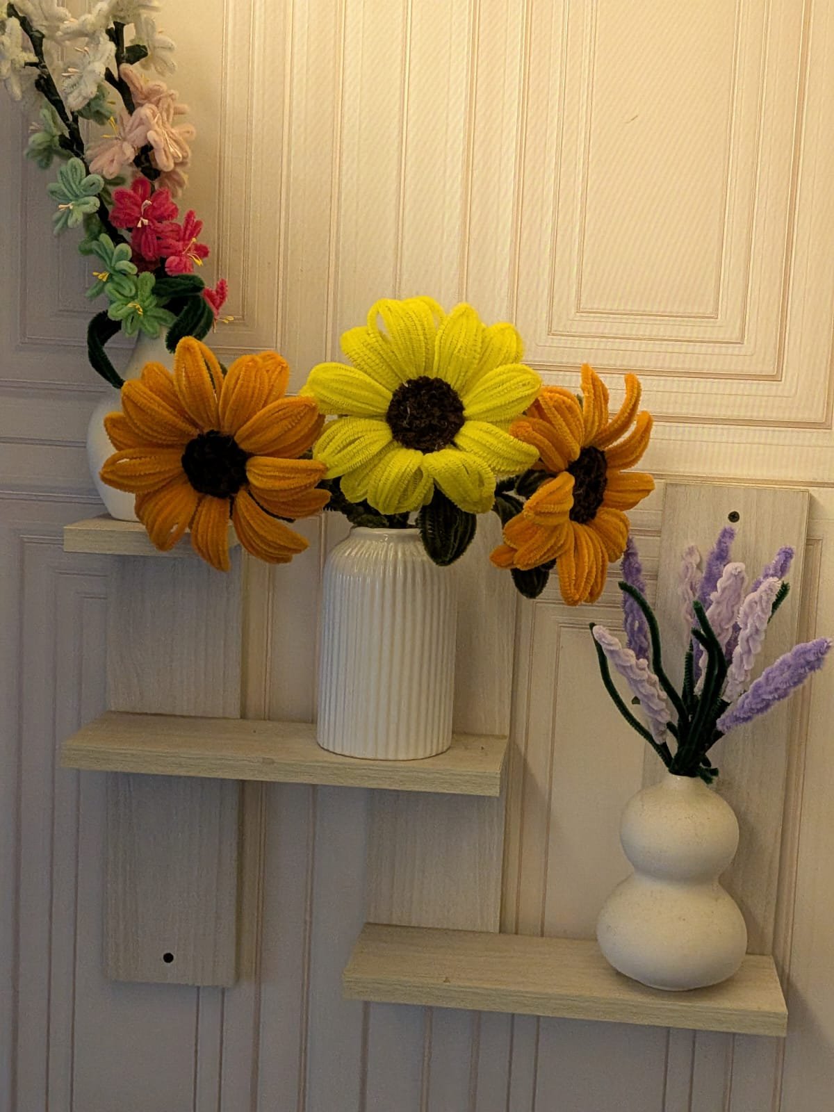Crochet sunflower trio with wildflower and lavender sprigs